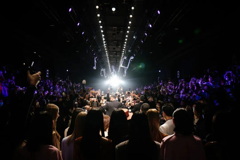 crowd at a live event with bright lights and musical notes decor