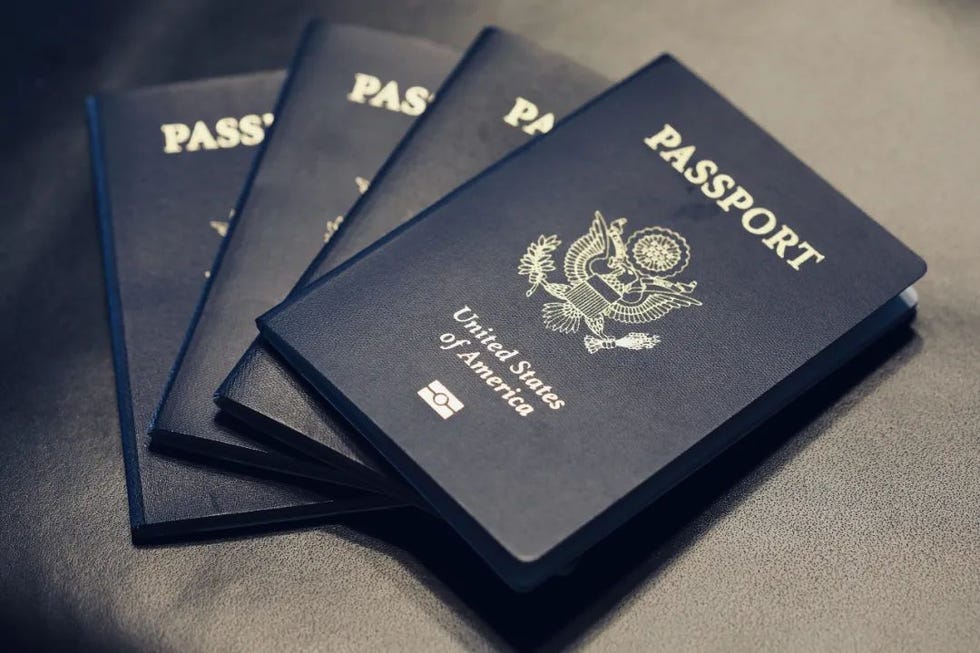 collection of us passports on a dark surface