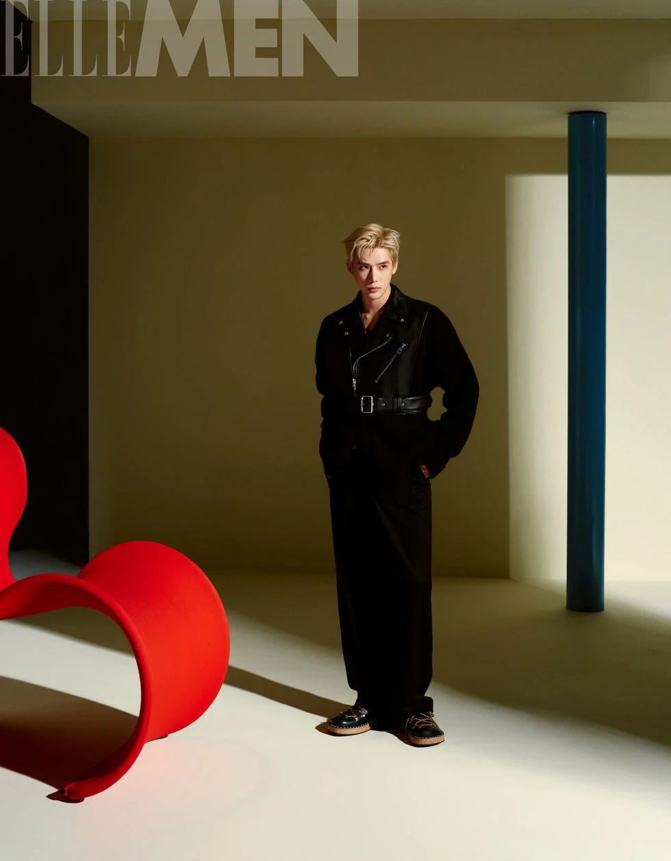 a stylish individual stands confidently in a modern setting highlighting fashion and design