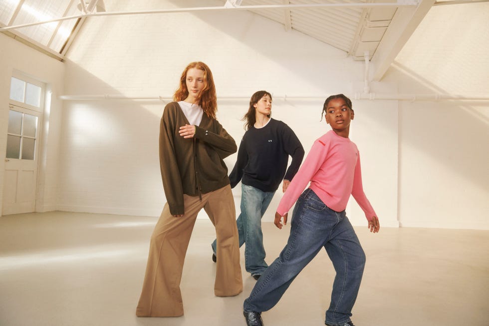 four individuals posing in a bright spacious indoor environment