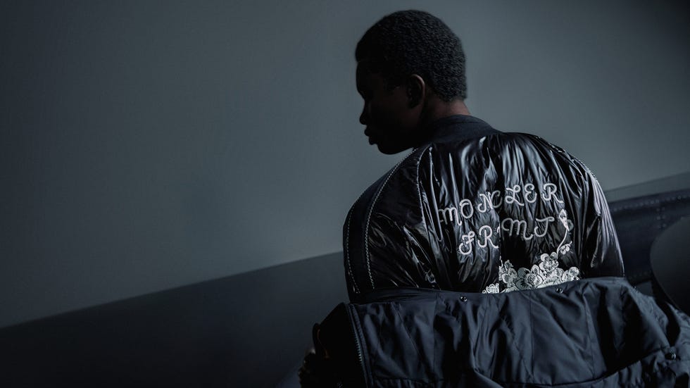 individual wearing a stylish black jacket with embellishments
