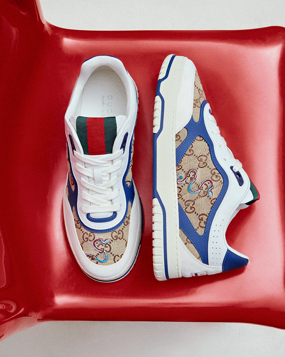 gucci sneakers with a beige monogram pattern and blue accents
