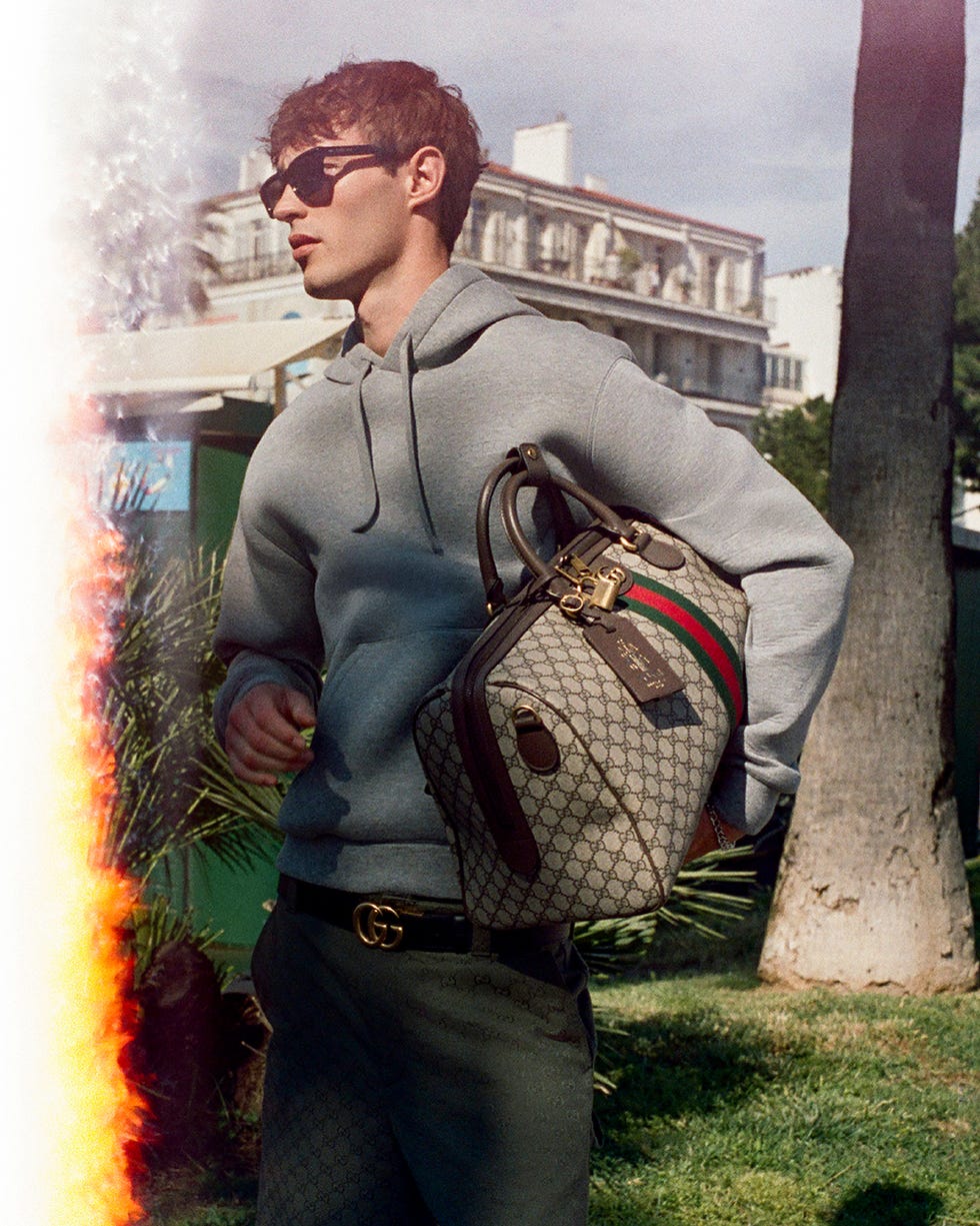 fashionable figure wearing a hoodie and luxury handbag