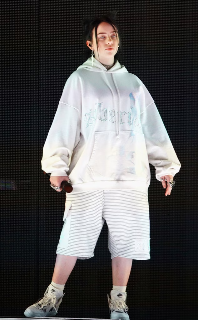 a man wearing a white shirt and white shorts