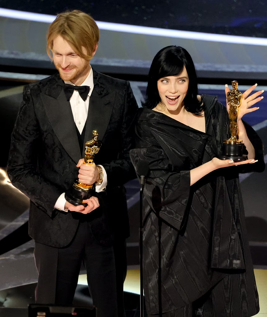 a man and woman holding trophies