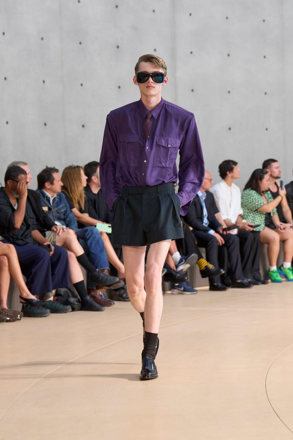 Fashion model displaying a modern outfit during a runway show
