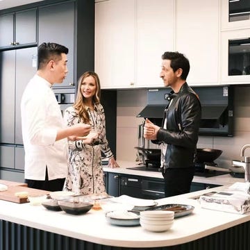people engaged in conversation in a modern kitchen setting people engaged in conversation in a modern kitchen setting