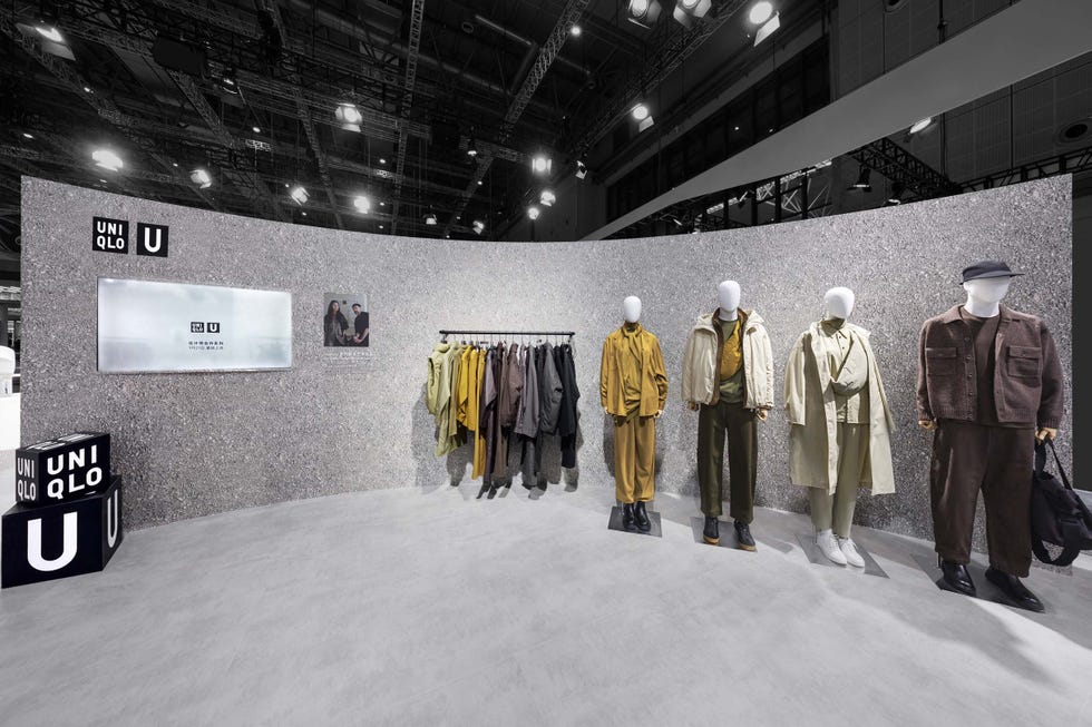 fashion display featuring mannequins dressed in various outfits against a textured gray backdrop