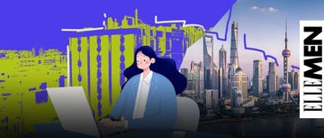 person working on a laptop with a city skyline in the background