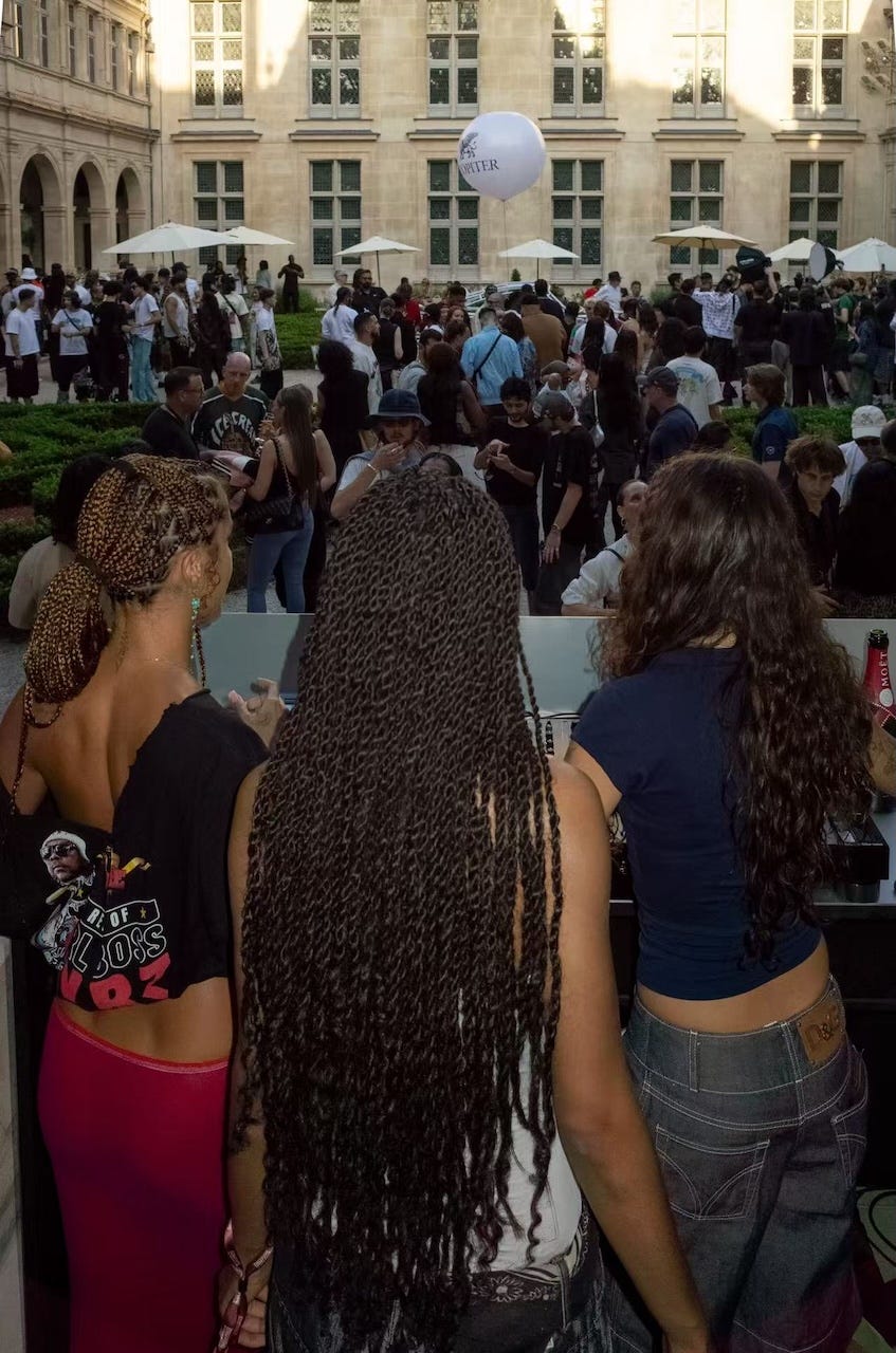 a bustling outdoor event with attendees interacting in a courtyard