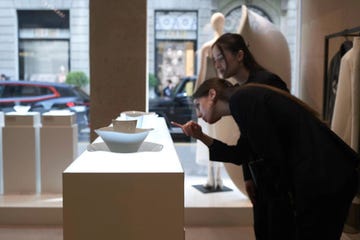 a man and woman looking at a box