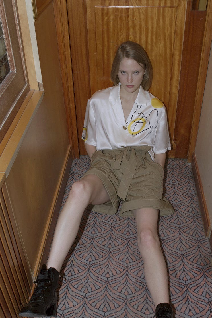 Clothing, Leg, Sitting, Knee, Footwear, Blond, Human leg, Thigh, Shorts, Blouse, 