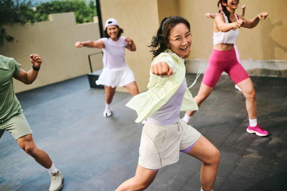 group exercise session outdoors with individuals demonstrating various poses