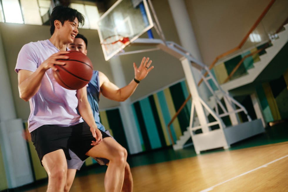 two players engaged in a basketball game on a court
