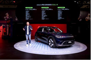 electric vehicle launch event with pricing displayed