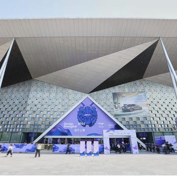 exterior of a modern exhibition venue for design shanghai 2025 featuring a large entrance and promotional banners exterior of a modern exhibition venue for design shanghai 2025 featuring a large entrance and promotional banners