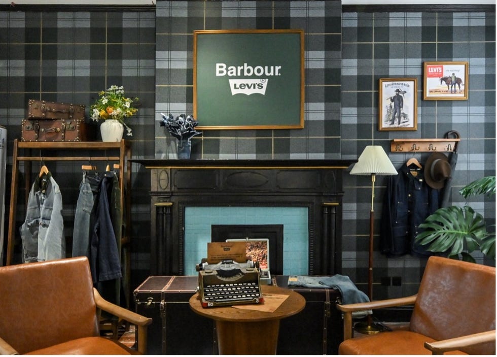 room featuring vintage decor with clothing displays and a typewriter