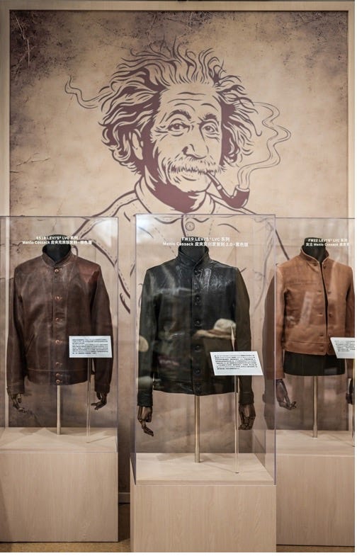 display of three leather jackets in a museum exhibit