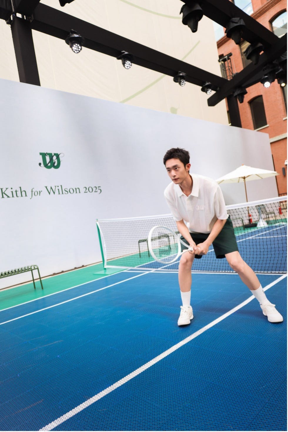 tennis player preparing to serve on a blue court