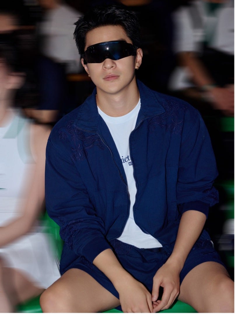 a person wearing a blue athletic outfit sitting down in a sports setting