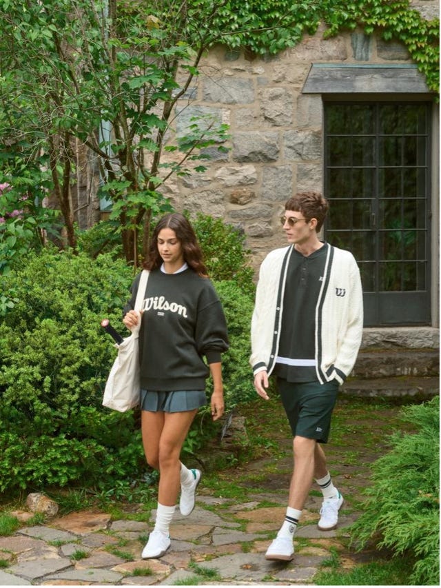 two individuals walking in a garden area