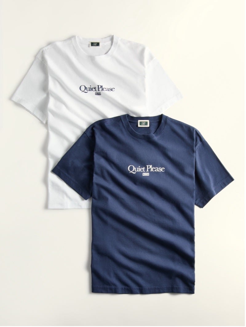 two tshirts featuring a brand logo one white and one navy