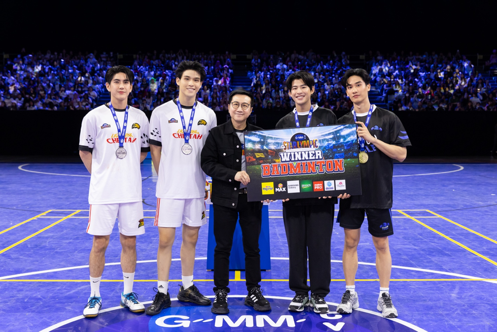 a group of men holding a trophy