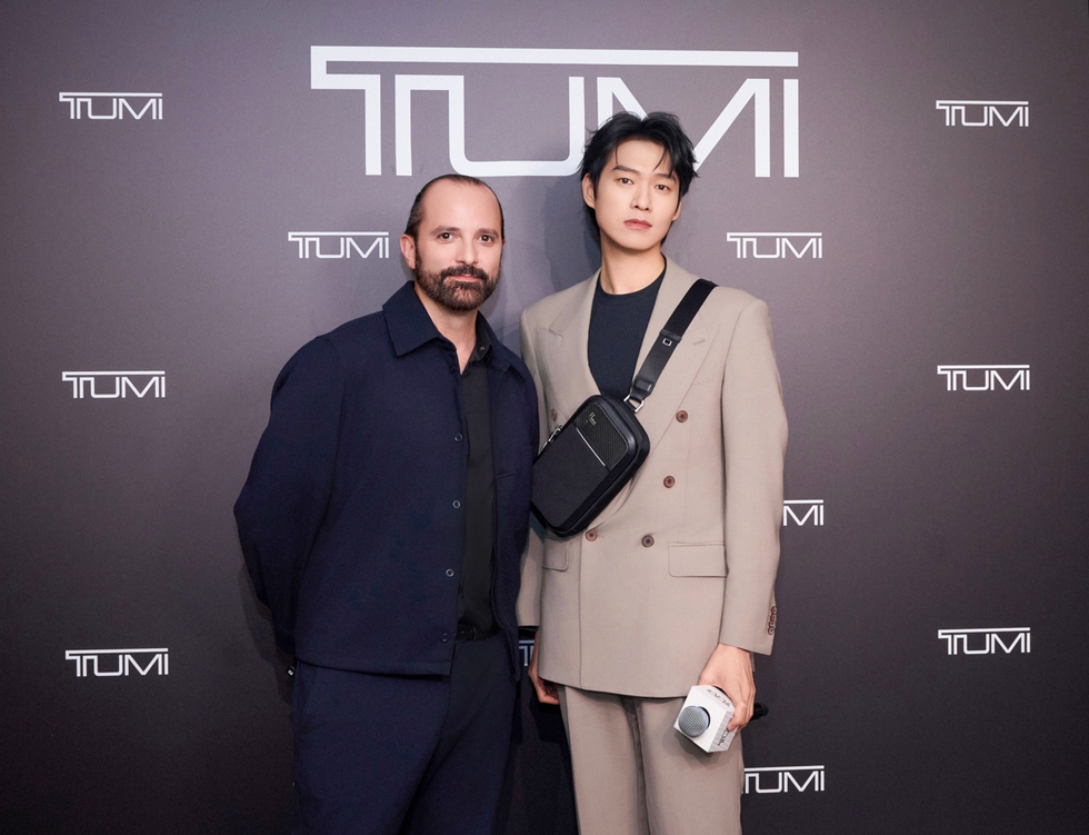two individuals posed together at a tumi event
