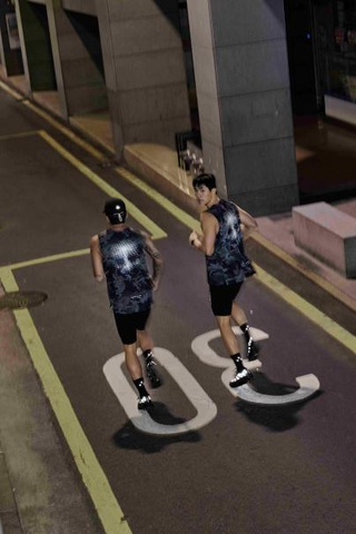 two individuals jogging on a nighttime city street
