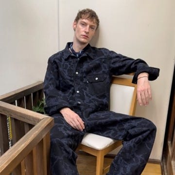 individual seated on a chair dressed in a patterned denim outfit individual seated on a chair dressed in a patterned denim outfit