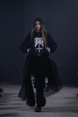 fashion model showcasing a streetwear outfit on a runway