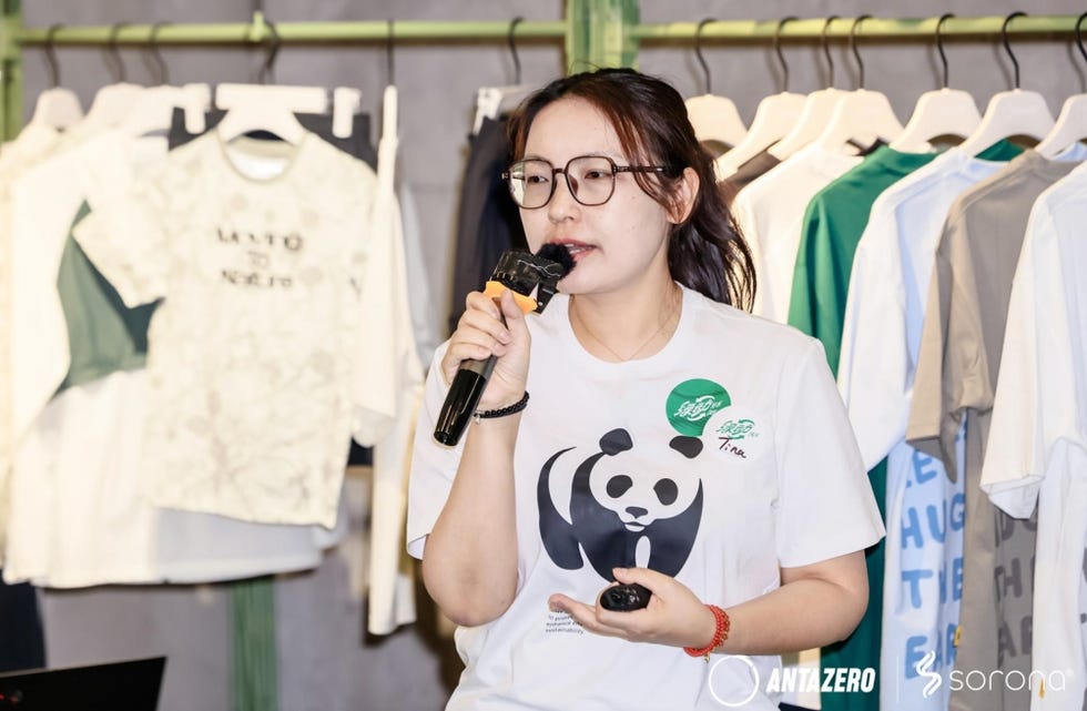 person speaking at an event promoting clothing items