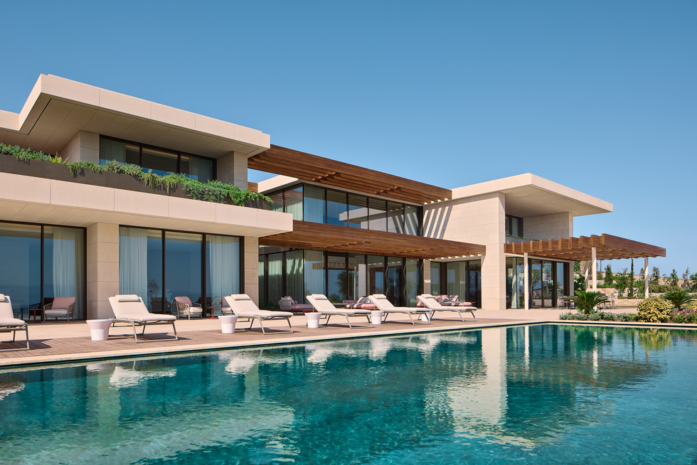 modern villa with a large swimming pool and lounge chairs