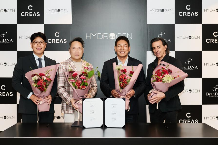 group of individuals holding bouquets at a signing event