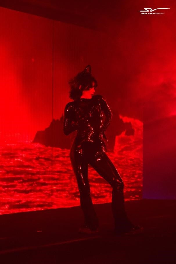 a performer on stage with dramatic lighting