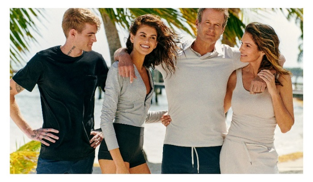 group of four individuals posing together outdoors