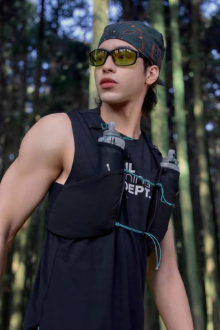 runner wearing a hydration vest in a forest environment