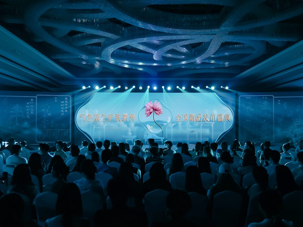 a conference or presentation event featuring a large screen with graphics and texts