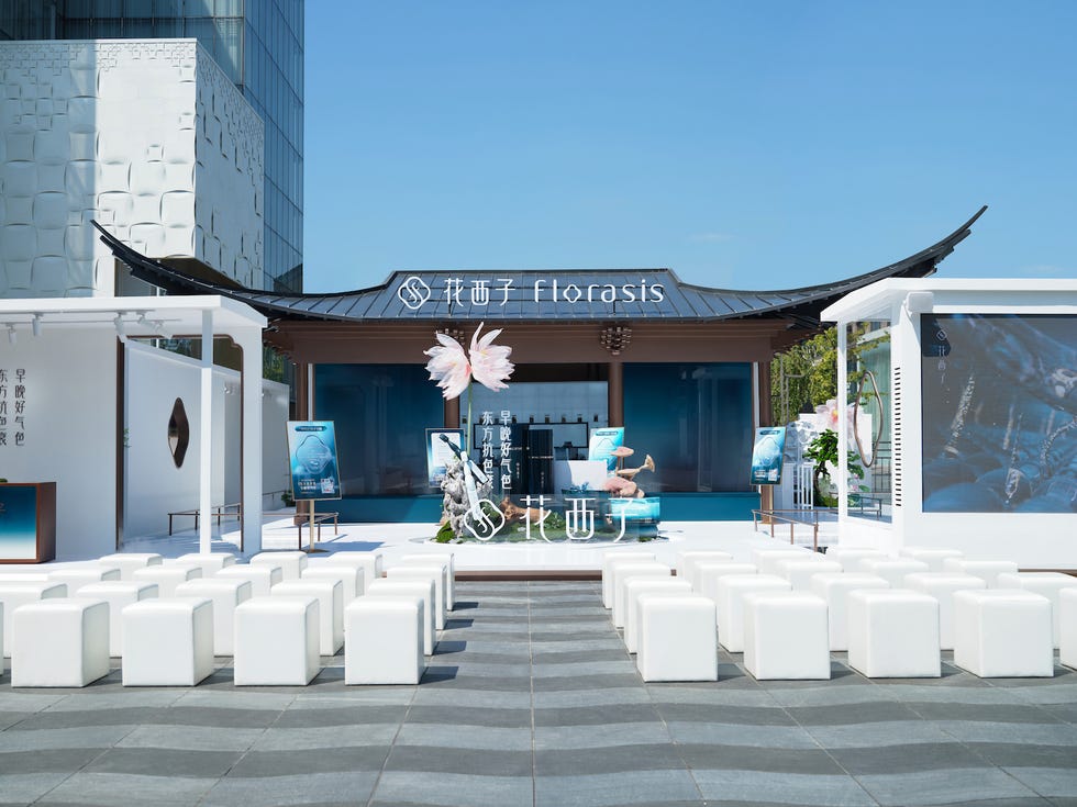 exhibition booth for cosmetics brand with seating arrangement