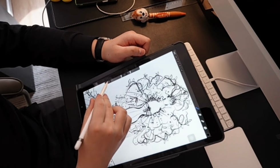 a person drawing on a black board