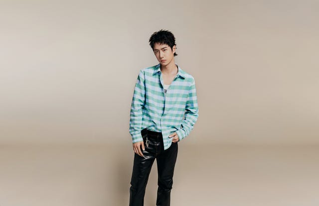 a man standing in front of a white wall