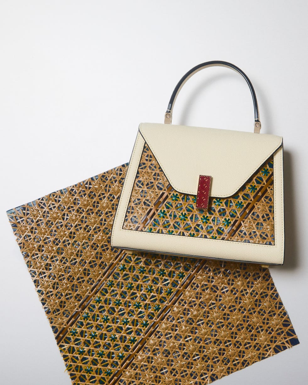 a stylish handbag placed on a decorative patterned surface