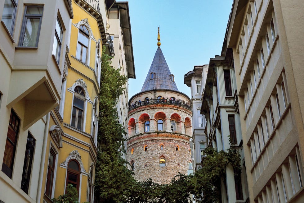 historical tower surrounded by narrow buildings