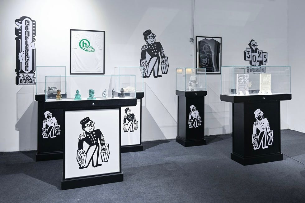 exhibition setup featuring display cases and wall art
