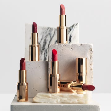collection of lipsticks in various shades displayed on geometric podiums