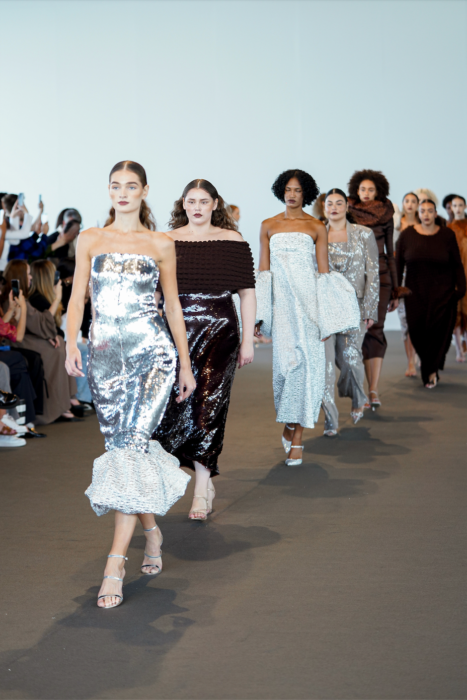 a group of women walking on a beach
