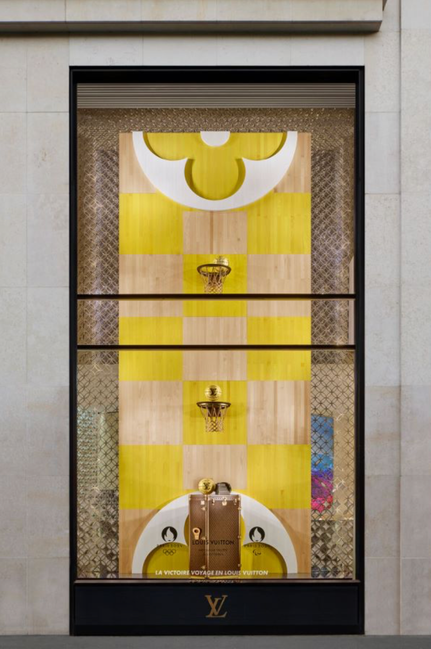 a framed painting of a yellow and black door with a gold emblem