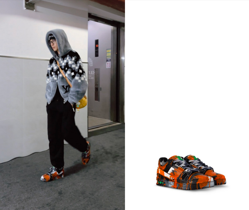 a person wearing a hooded jacket black pants and unique sneakers walking in a hallway