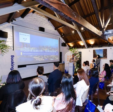 Presentation at a professional event with attendees seated Presentation at a professional event with attendees seated