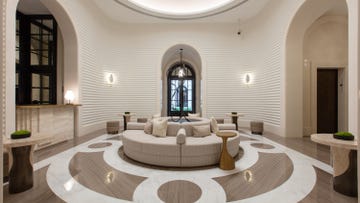 a large room with a large glass door and a large round table